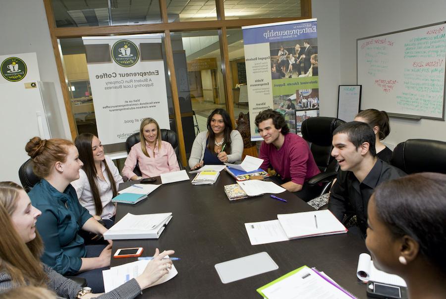 Group of business students around a table.