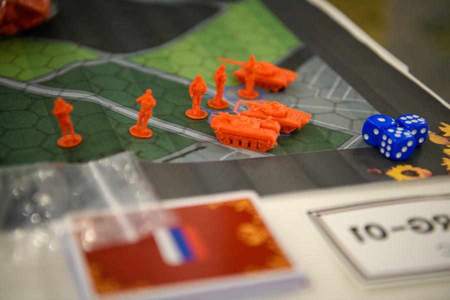 Small military figurines are placed upon a board game map.